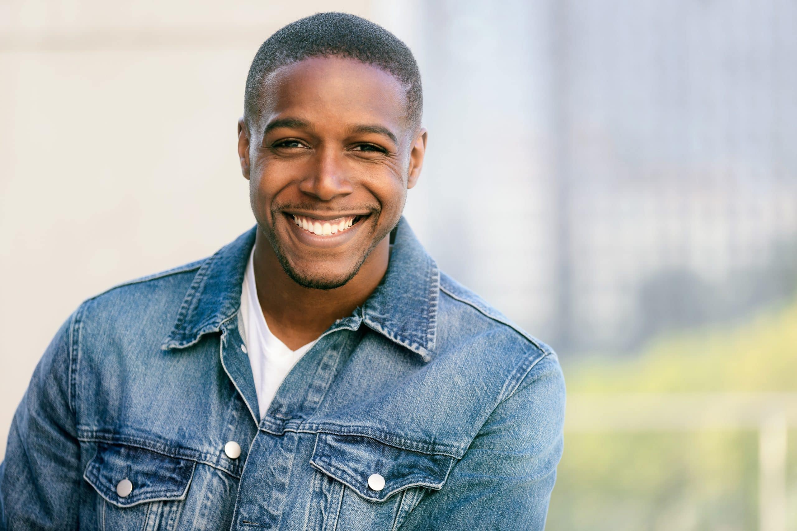 Close up of a young African American man with straight white teeth smiling