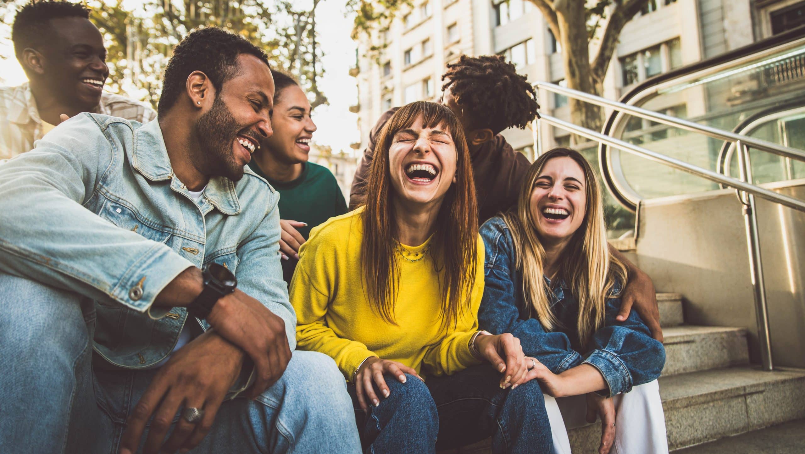 multicultural group of friends laughing together