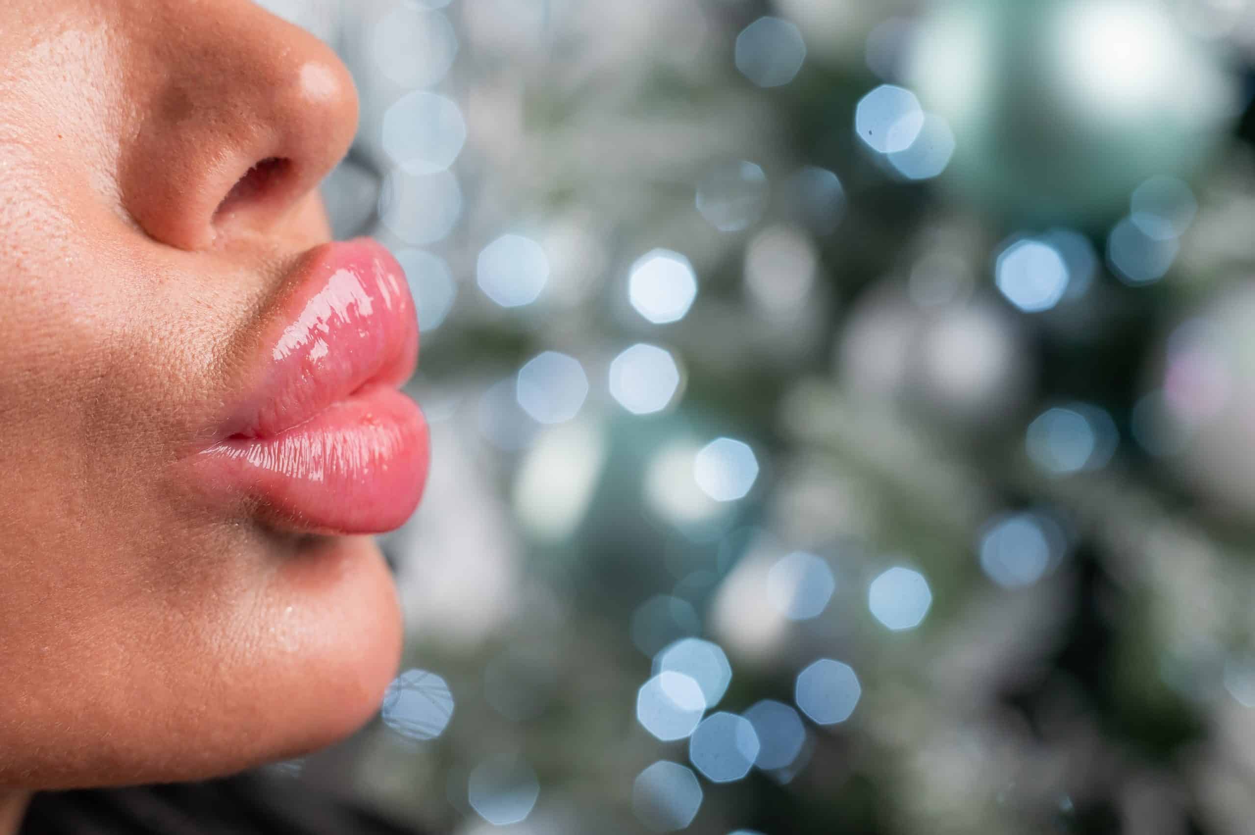 Woman with very full lips puckers