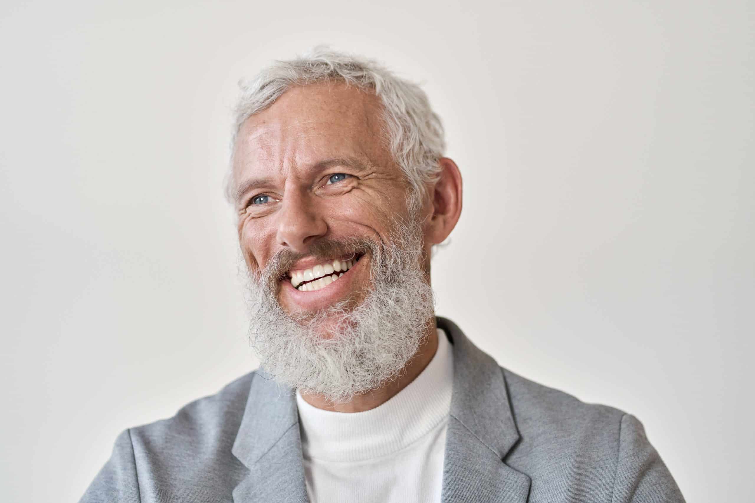 Older gentleman with gray beard smiling