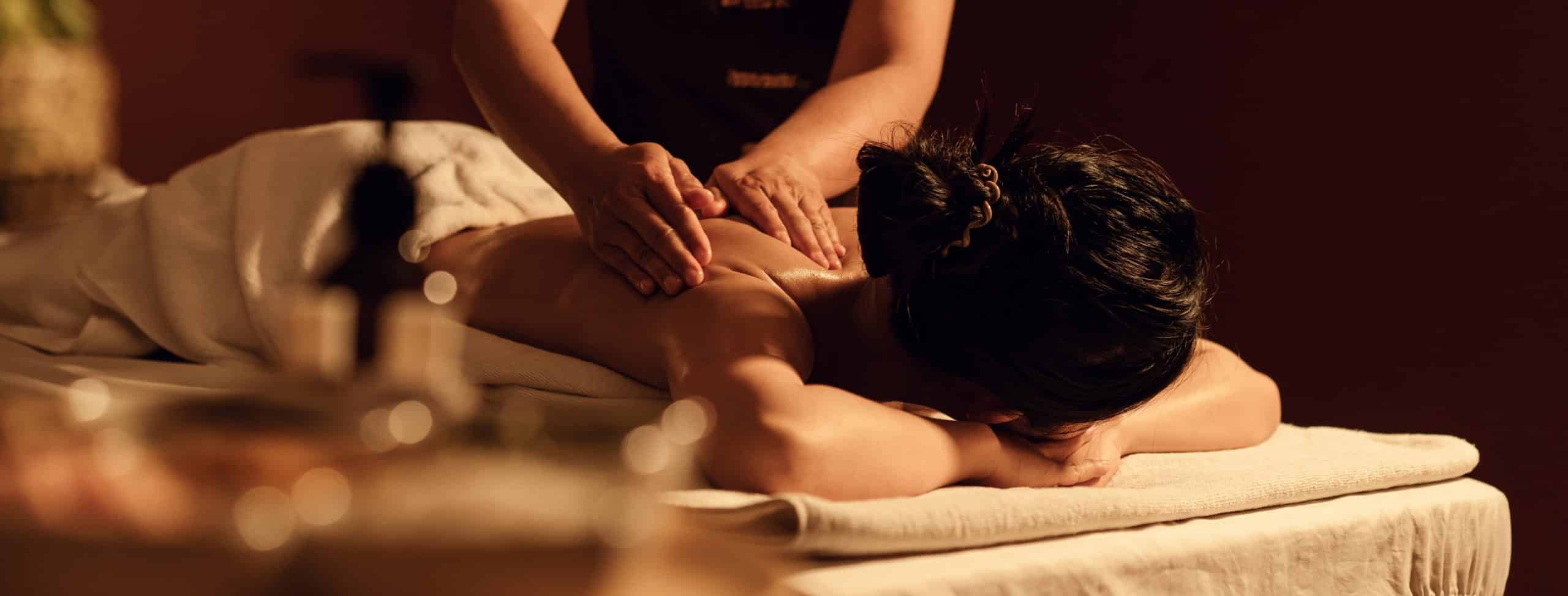 woman relaxes on table while getting a massage