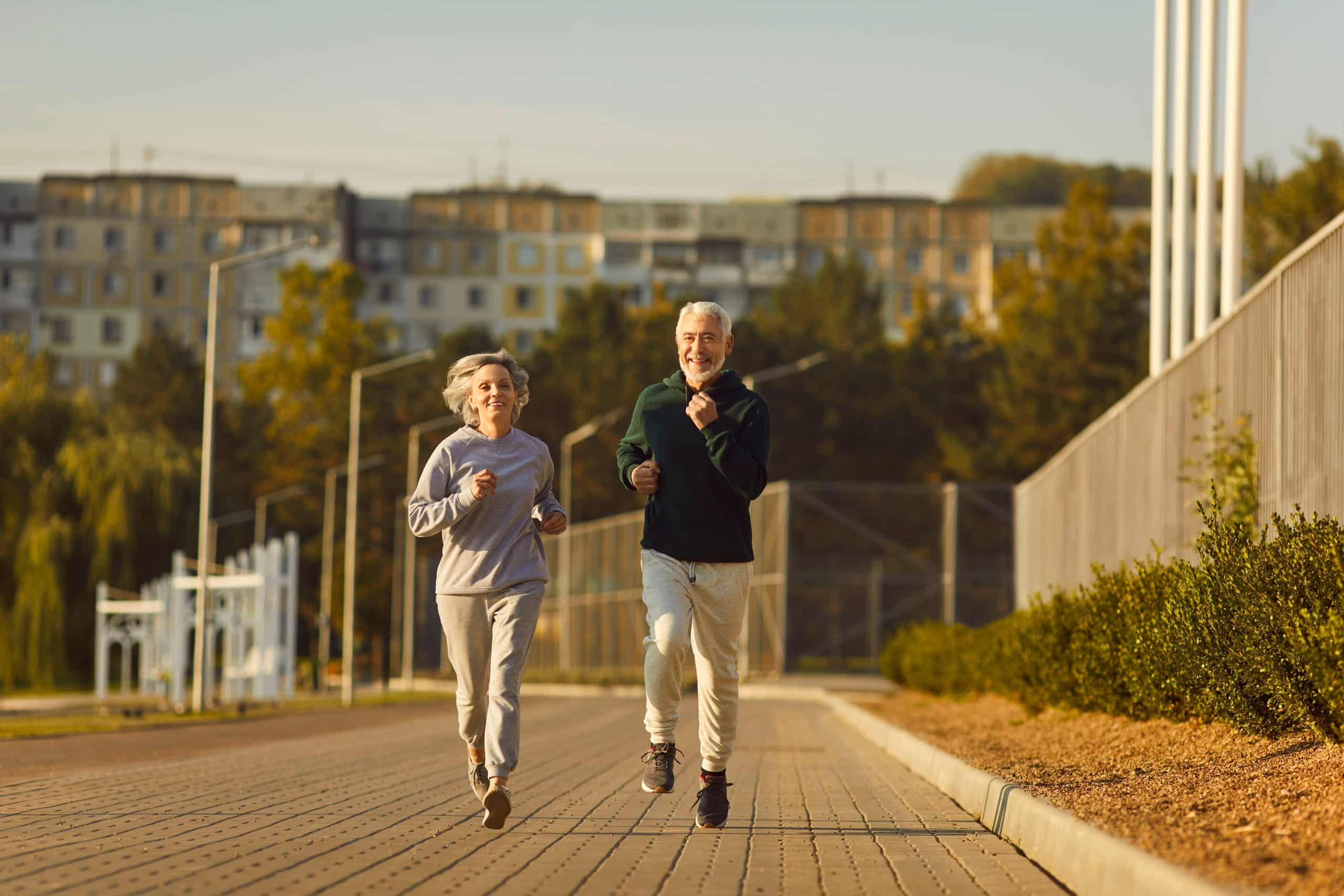 Senior aged man and woman jogging together