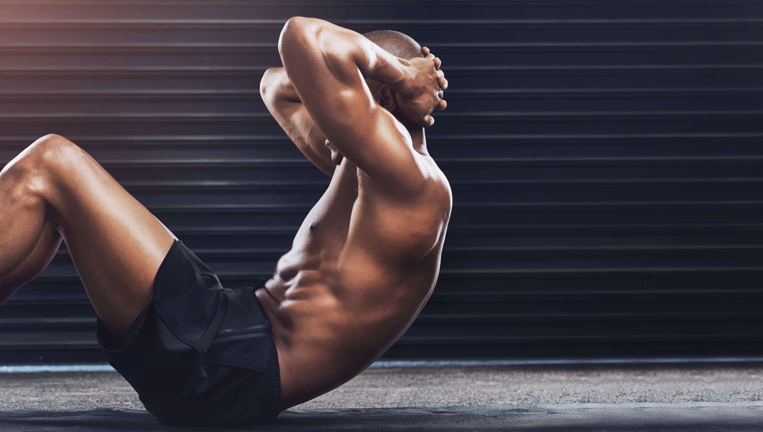 Toned, fit Black man doing crunches