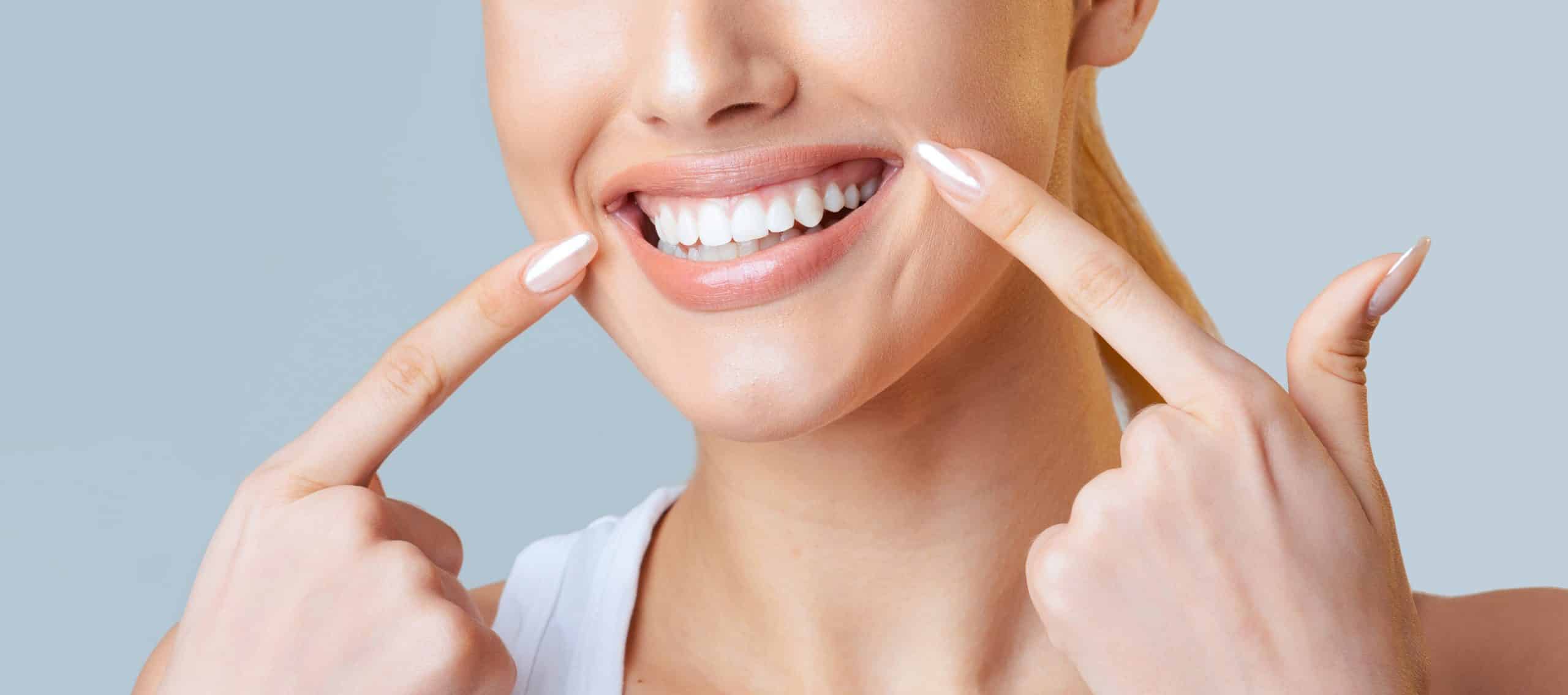 Close up of woman pointing at her wide smile