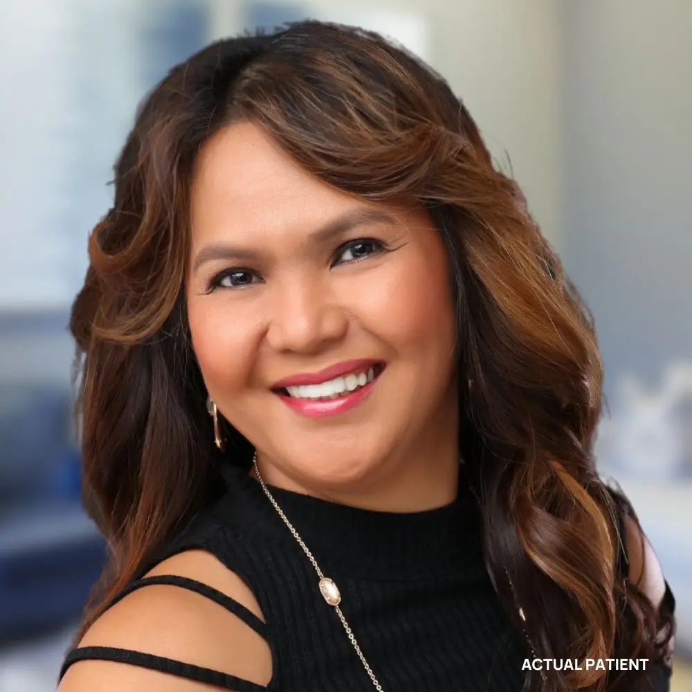 Patient smiling confidently after restorative dental care