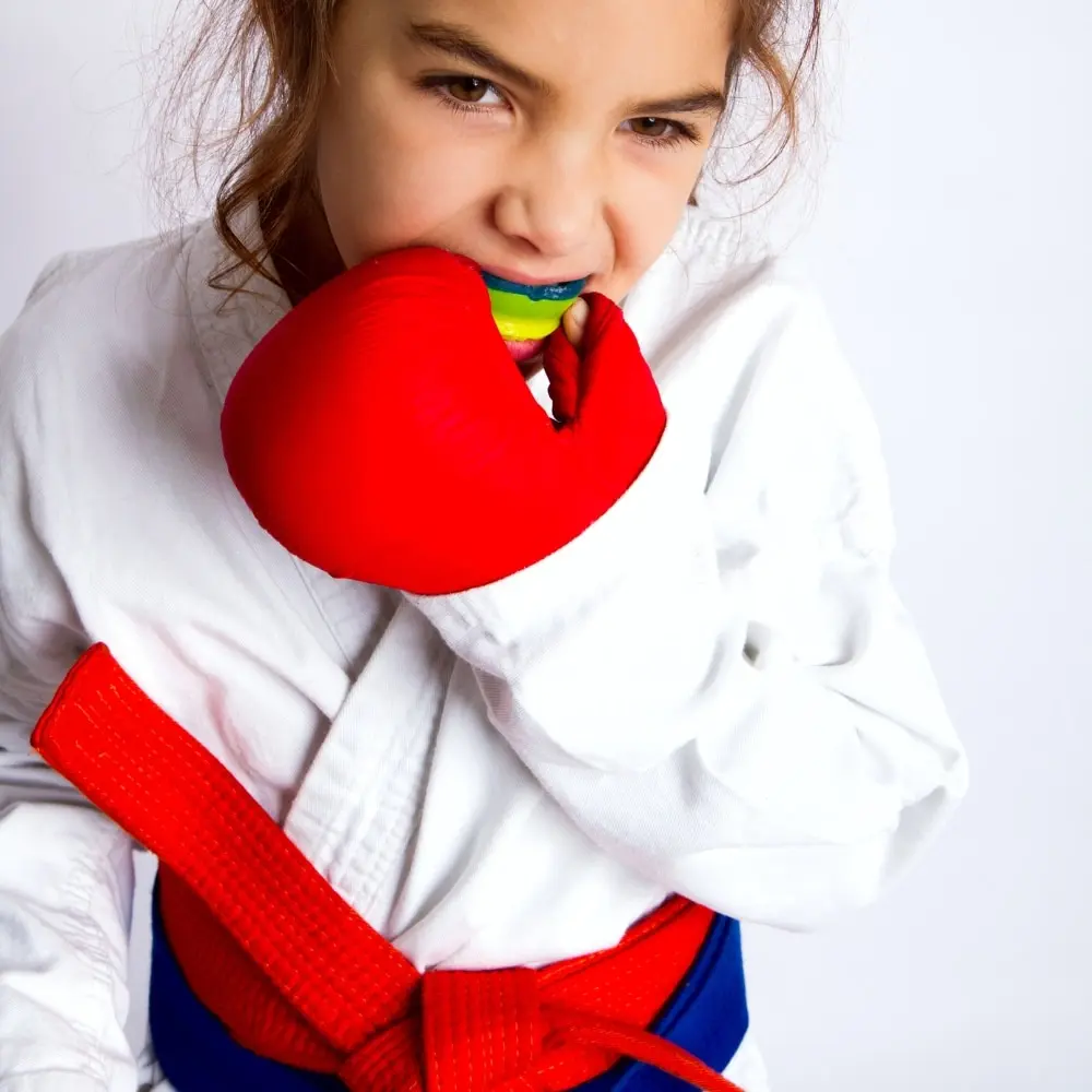 Custom athletic mouthguard protecting a young athlete’s smile