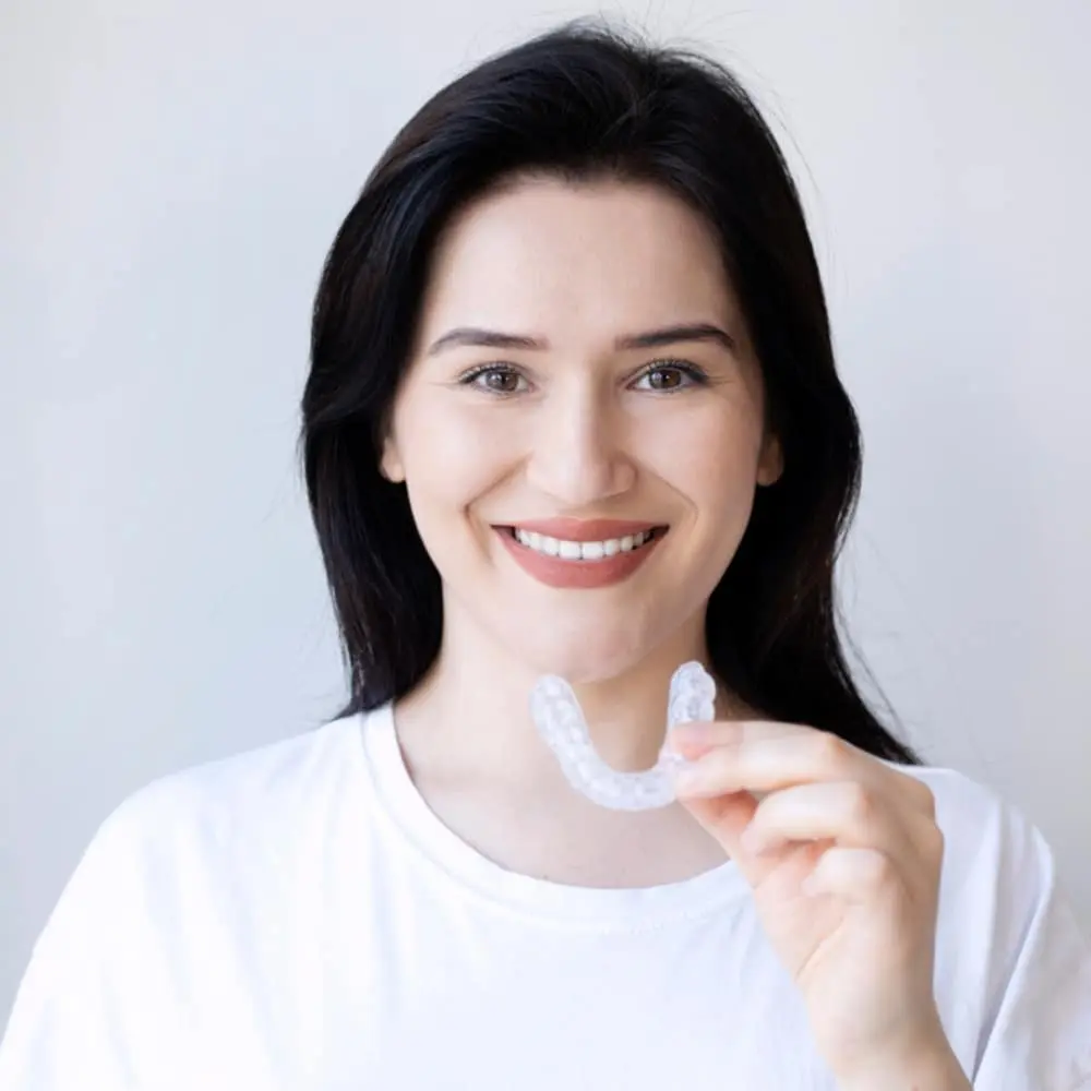Patient holding a custom dental nightguard