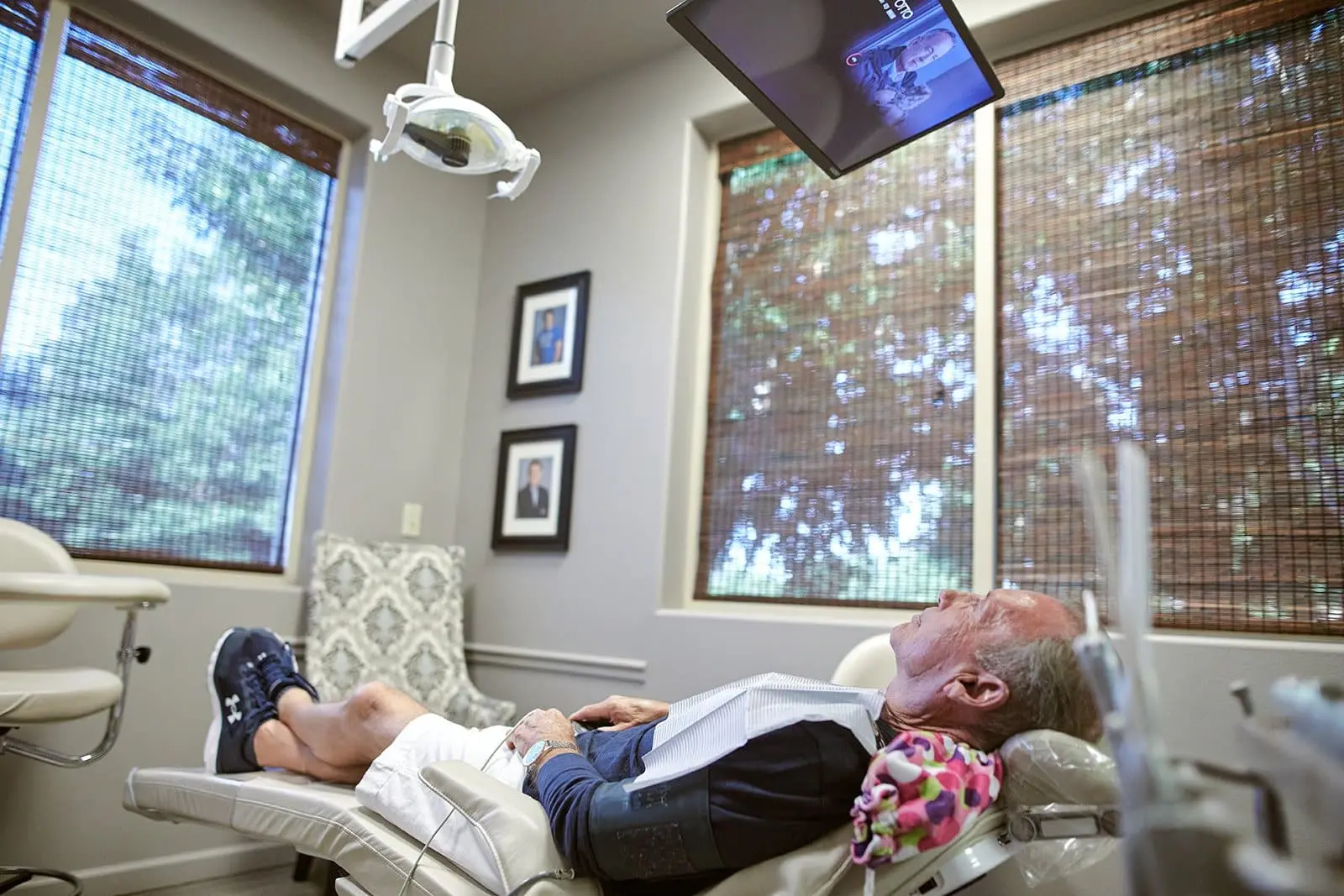 Patient relaxing in a dental chair beside a window at Stonebriar Smile Design