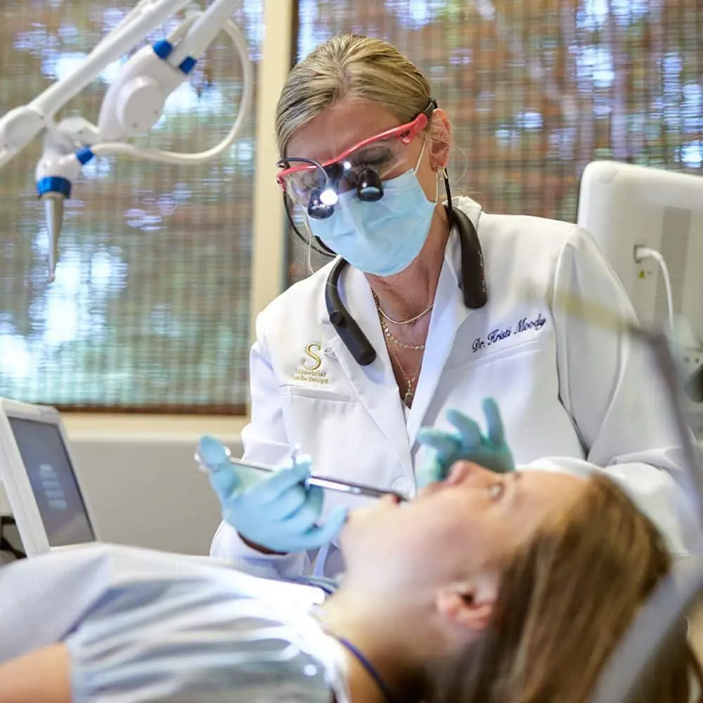 Dentist administering OraVerse after completing dental treatment