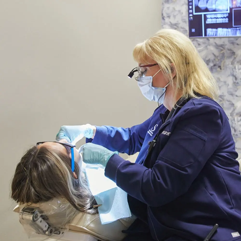 Dental hygienist cleaning a patient's teeth