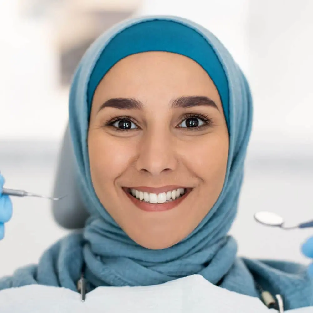 Dentist selecting tooth-colored composite resin for cosmetic bonding