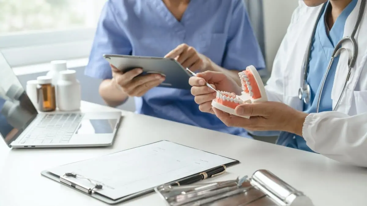 Dental professional discussing wellness-focused care with a patient